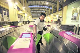A worker cleans the entrance of a Metro station in Bangalore on Saturday. Metro train will be launched by Union Urban Development Minister Kamal Nath in the city on October 20