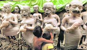 Festive fervour: Children admire clay idols of goddess Kali and others prepared for the upcoming Kali Puja and Diwali festivals in Kolkata on Sunday