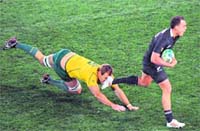 New Zealands Israel Dagg escapes with the ball infront of Australias Rocky Elsom during the Rugby World Cup semifinal in Auckland on Sunday