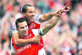 Arsenals Robin Van Persie (bottom) celebrates his goal against Sunderland with Theo Walcott in London on Sunday