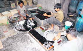 Young artisans preparing edible sugar toys at a shop at Mishri Bazaar in Amritsar on Monday