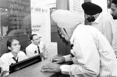 Formally dressed employees of the Punjab Police attend to a visitor at the Phase VIII outreach centre in Mohali on Monday. 
