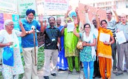 Protesters raise their voice outside the police headquarters at Sector 9 in Chandigarh on Monday