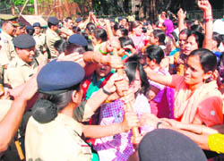 Anganwari workers are prevented by the police from proceeding towards the Chief Ministers residence in Dehradun on Monday. 