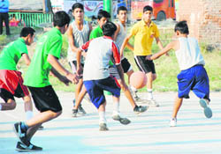 Players in action in the District Basketball Tournament in Dehradun on Monday. 