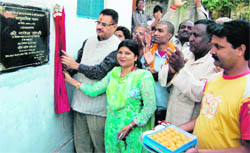 Legislator Ganesh Joshi inaugurates a community centre in his constituency in Dehradun on Monday. 