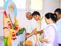 MP Ashok Tanwar, CPS Prahlad Singh Gillankhera and Mahila Congress president Usha Dahiya offer flowers to Bhagwan Balmiki on the Balmiki Jayanti at Fatehabad.