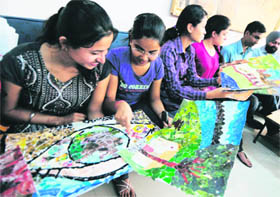 Students take part in a collage making competition during the Youth Fest at PAU in Ludhiana on Monday. 