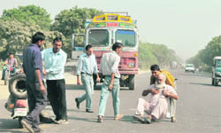 Passersby lend help to an accident victim on the Mullanpur road.