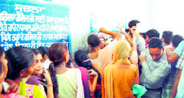 Patients jostle with each other to stay in the queue at the cash counter in the Amritsar Civil Hospital on Tuesday.