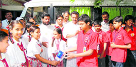 School students hand over plastic bottles to members of the Clean India Yathra in Amritsar on Tuesday.