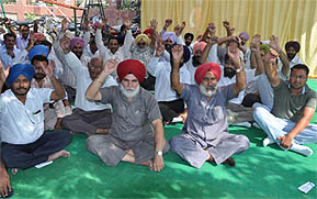 Diploma engineers staging a protest outside the office of the Deputy Commissioner in Bathinda on Tuesday.