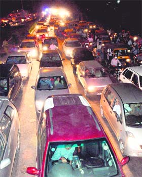 Vehicles stuck in a traffic jam on the road from the airport to the roundabout separating Sector 29 and Phase II of Industrial Area in Chandigarh on Tuesday
