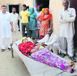 Priyanka, who delivered a stillborn baby in an ambulance, with her family members at Lalwas in Fatehabad. 