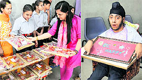 Students of Udaan Special School display designer Diwali earthen lamps and (right) Taranjit Singh, a special child, shows a wall-painting at an exhibition in Jalandhar on Tuesday.
