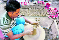 With Diwali round the corner, a potter is busy making earthen lamps in Jammu