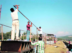 Workers busy setting up cracker stalls at Prem Nagar in Jammu