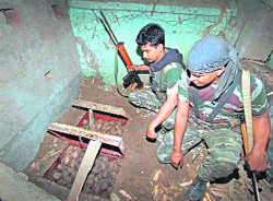 RAF personnel look at trunks packed with 1,000 bombs in the abandoned house of a CPM supporter at Pilkhundi village in Birbhum district of West Bengal on Tuesday