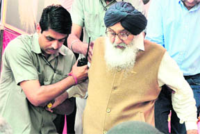 Chief Minister Parkash Singh Badal being helped by his security guards at a function in Ludhiana on Tuesday. 