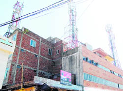 Three mobile phone towers installed on the roof of a school on Majitha Road in Amritsar.