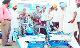 Visitors to the kisan mela take a look at farm implements in Amritsar on Wednesday.