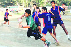 Players in action in a match in the District Handball Tournament played at the Parade Ground in Dehradun