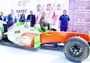 Chief Minister Omar Abdullah poses with a Sahara Force India Formula One car during the raise the flag campaign in Srinagar on Wednesday. 