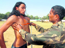 An Army personnel measures the chest of a candidate at the open recruitment rally at Guru Nanak Stadium in Kapurthala on Wednesday