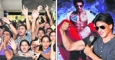 Fans cheer as Bollywood star Shahrukh Khan flexes his muscles during a promotional tour in Ludhiana on Wednesday