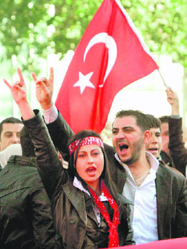 Demonstrators shout slogans to protest an attack against the Turkish military on Wednesday in the heart of Ankara