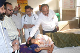 Dr JP Singh, Director, Health, meets a patient at the Civil Hospital. 