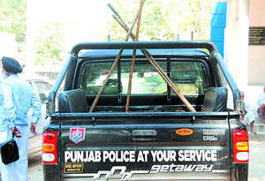 A Punjab Police vehicle equipped with batons boasts of serving public. But protesters are the ones who end up being served. 