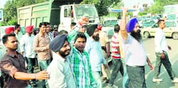 MNREGA employees block a road in Phase VII at Mohali on Thursday.