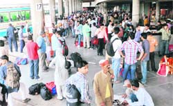 Passengers await the resumption of bus services in Chandigarh on Thursday.