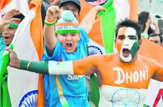 Fans cheer for the Indian team during an ODI against England at the PCA Stadium in Mohali on Thursday. 