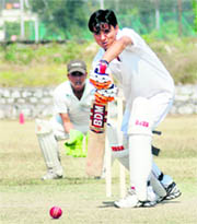 A batsman plays a defensive shot in a match in the Uttarakhand Technical University Inter-college Cricket Tournament in Dehradun on Thursday.