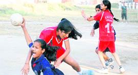 A match under way in the District Handball Tournament played at the Parade Ground in Dehradun on Thursday.