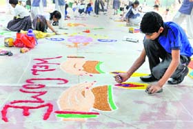 Participants make rangoli during a competition organised by Bal Bhawan in Karnal on Thursday