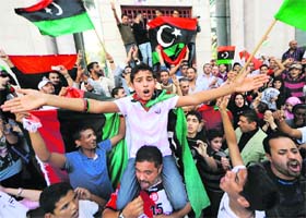 THE JOY: Libyans staying in Tunis break into celebrations after the news of Gaddafis death