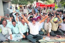 Members of the Jammu and Kashmir SRTC Workers Union hold a protest in Jammu on Thursday. 