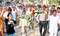 Relatives of Nitika burn an effigy of her husband near Company Bagh in Jalandhar on Thursday