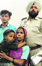 The accused in police custody and the rescued boy with his mother.