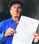Devinder Khurana shows a copy of the police cancellation report in Ludhiana on Thursday. 