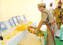 Fazilka SSP RK Sharda lays a wreath on the photos of Punjab Police martyrs in Fazilka.