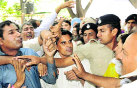 Congress workers from Hisar scuffle outside the Haryana Congress office to reach the venue of the meeting in Chandigarh on Friday. 