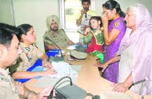 A deserted NRI wife narrates her tale of woes to senior police officials at a public hearing in the Police Lines in Jalandhar on Friday. 
