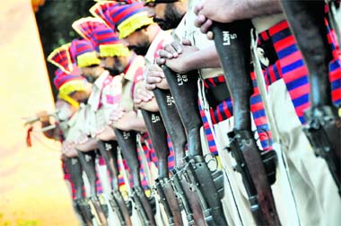 Police personnel lower their weapons as a mark of respect to martyrs on the Police Commemoration Day in Ludhiana on Friday. 
