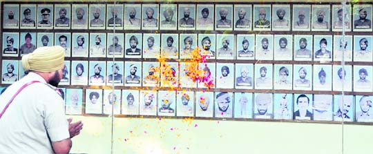 A policeman pays floral tributes to martyrs on the occasion of Police Commemoration Day in Ludhiana on Friday. 