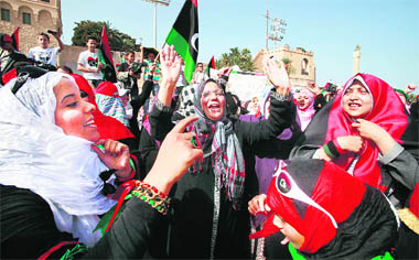 Women celebrate the death of former Libyan leader Muammar Gaddafi after Friday prayers at Martyrs' Square in Tripoli.