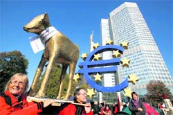 Protesters carry a self-made 'golden calf' in front of the European Central Bank and the Euro-statue through Frankfurt's banking district on Saturday during a demonstration against bankers, financiers and politicians they accuse of ruining global economies and condemning millions to poverty and hardship through greed